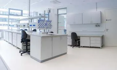 Bright laboratory with white workstations and wall-mounted cabinets