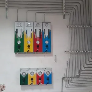 Wall-mounted gas control panels with colour-coded gauges and stainless steel lines